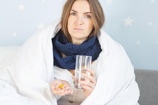 Photo influenza treatment flusick woman wrapped in warm scarf and blanket