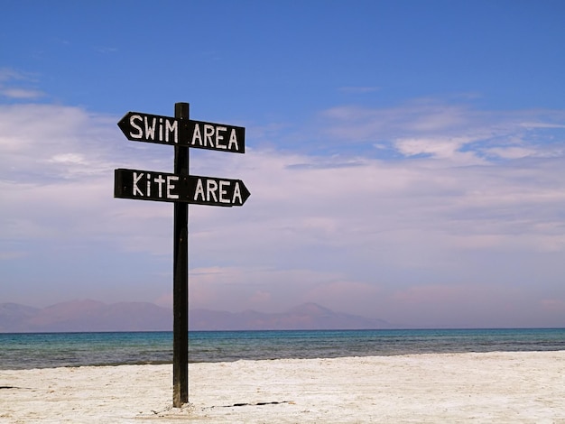 Foto informatiebord op het zand op het strand