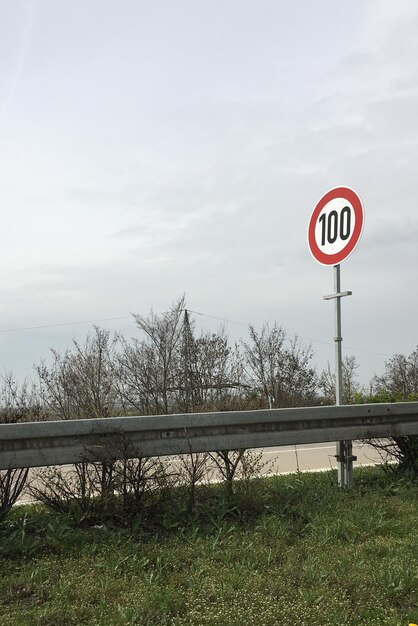 Information sign against sky