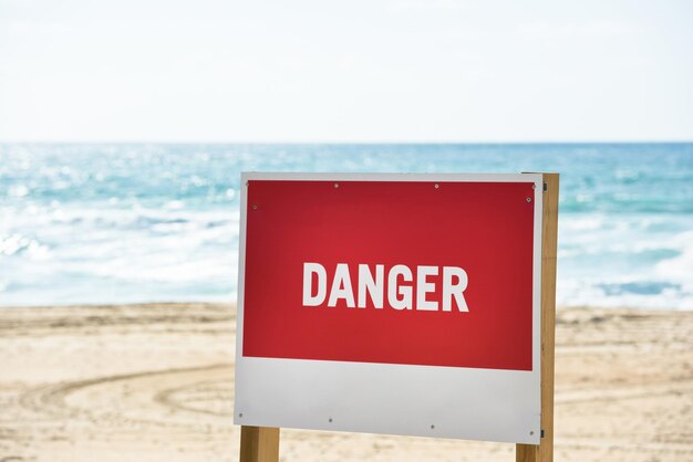 Photo information sign on beach against clear sky