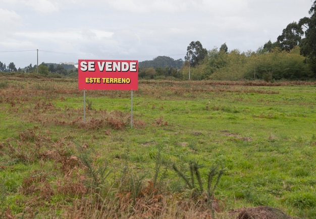 Information sign on field against sky