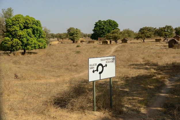 Information sign on field against sky