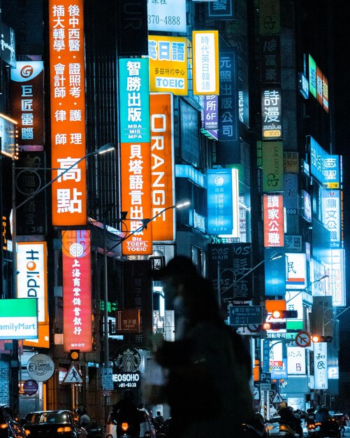Photo information sign on illuminated street in city at night