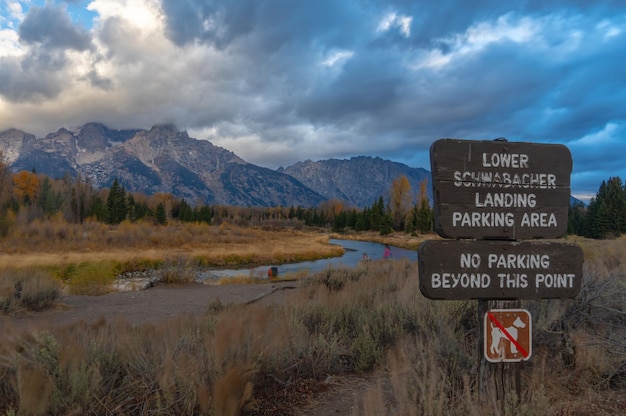 Photo information sign on landscape against sky