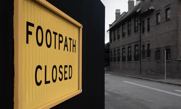 Photo information sign on road by buildings in city