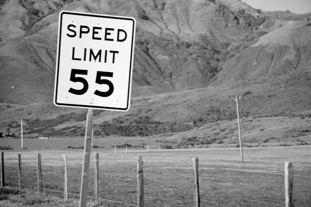 Photo information sign on road by land