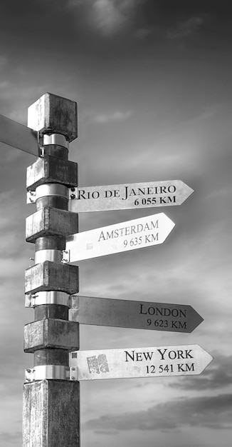 Information sign on wooden post against sky