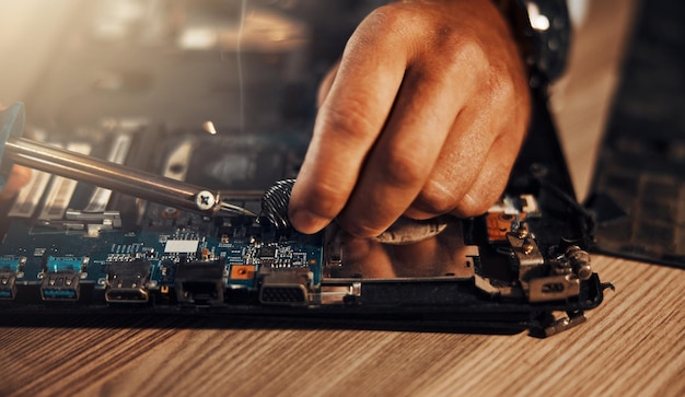 Information technology hands circuit soldering and man repair motherboard hardware electronics or semiconductor CPU system maintenance service industry and IT worker fixing microchip in tech lab