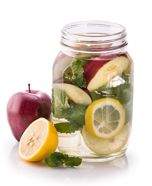 Infused fresh fruit water of lemon, apple and mint leaf. isolate