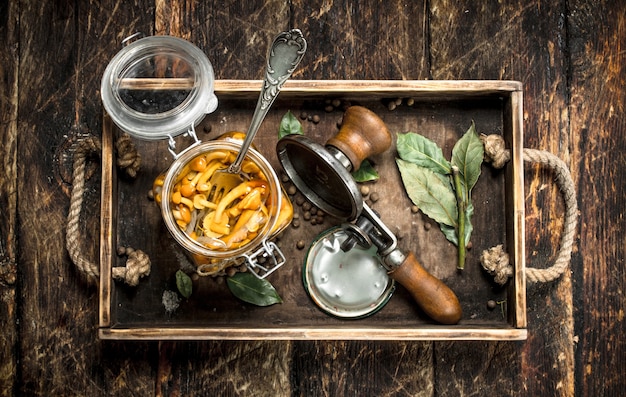 Ingemaakte champignons met seamer op een oud dienblad.