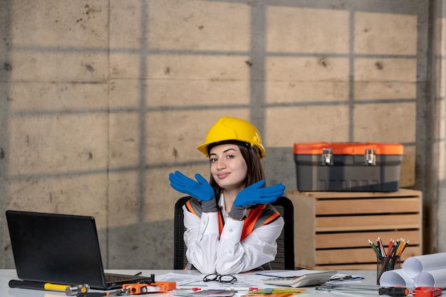 Ingenieur in helm en vest civiel werker slim jong schattig brunette meisje met handen op gezicht