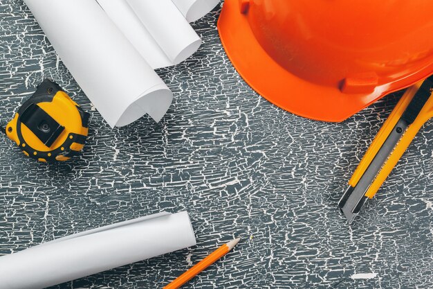 Ingenieurswerkplaats met blauwdrukken, kompas, potlood en veiligheidshelm