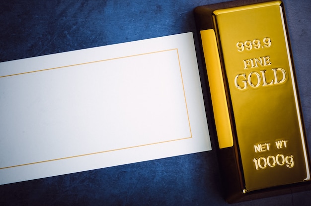 Слиток золотого металла в слитках чистого бриллианта, расположенный по диагонали на синем текстурированном фоне