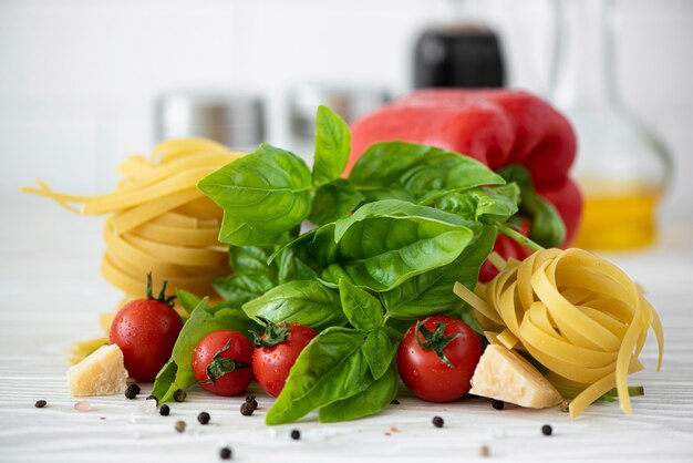 Ingrediënten voor fettuccine pasta met tomaten, kruiden en basilicum