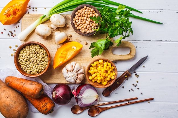 Ingrediënten voor plantaardige veganistensoep met linzen, paddestoelen en kekers op witte achtergrond.