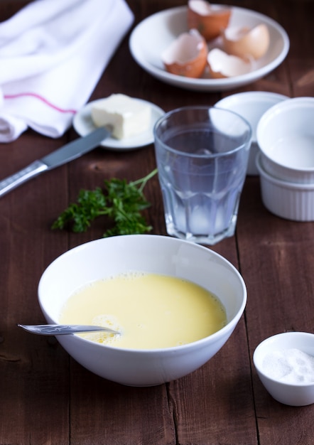 Ingredients and accessories for making omelet. Rustic style.