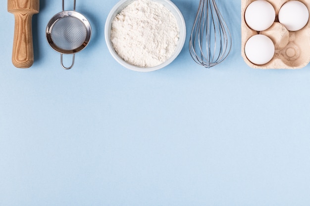 Ingredients for baking  on a blue background