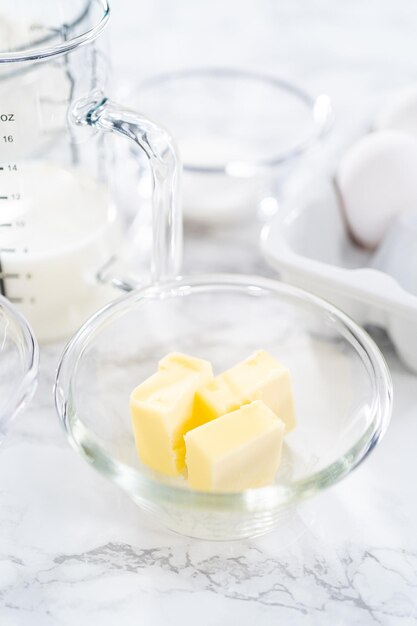 Ingredients for baking brioche buns on the kitchen table.