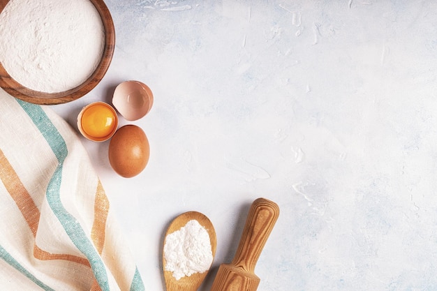 Photo ingredients for baking flour wooden spoon eggs