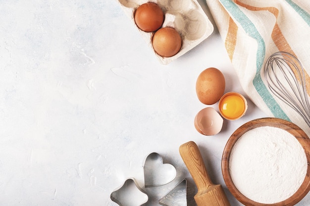 Ingredients for baking flour wooden spoon rolling pin eggs Top view copy space