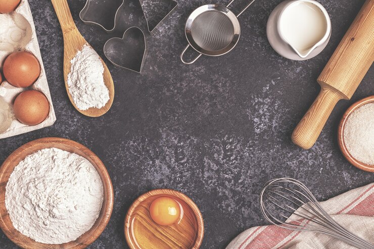 Photo ingredients for baking   flour wooden spoon rolling pin eggs top view copy space