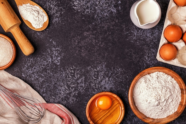 Ingredients for baking  - flour, wooden spoon, rolling pin, eggs