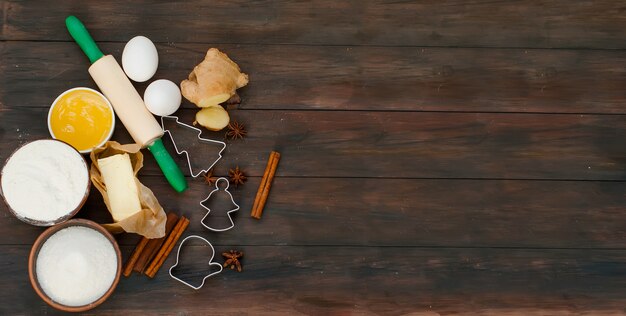 Ingredients for baking gingerbread on a dark table