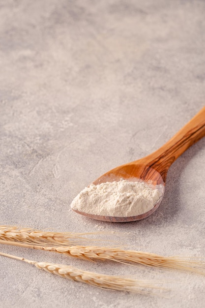 Ingredients for baking spoon with flour ears of wheat