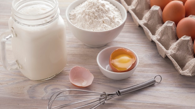 Ingredients for baking on a white wooden table. Ingredients