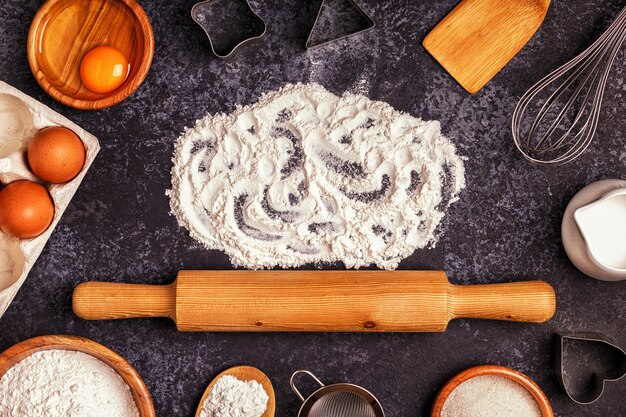 Ingredients for baking with flour, wooden spoon and rolling pin