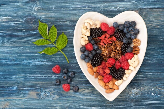 Ingredients for breakfast oat granola summer berries and nuts Top view horizontal