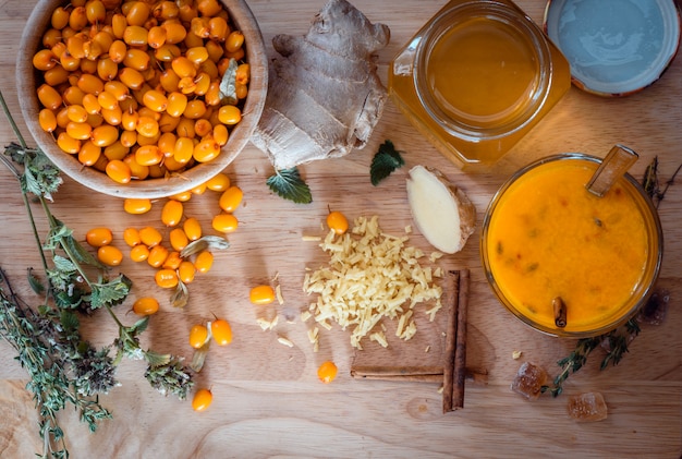 Ingredients for cocktail recipe with seaberries and honey