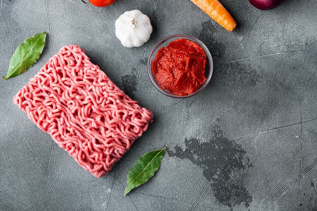 Photo ingredients for cooking bolognese sauce, minced beef meat tomato and herbs set