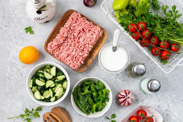 Ingredients for cooking Greek meatballs with salad and tzatziki sauce