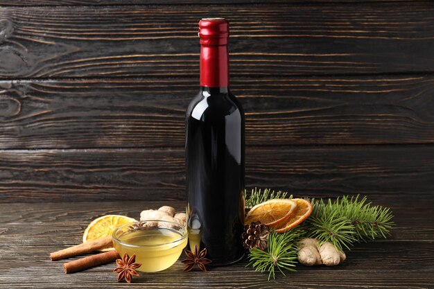 Ingredients for cooking mulled wine on dark wooden table