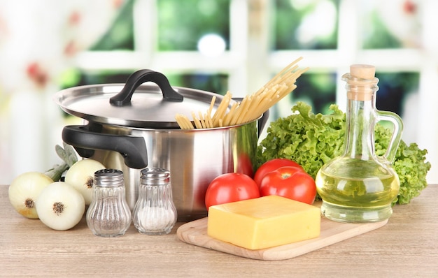 Ingredients for cooking pasta on table in kitchen