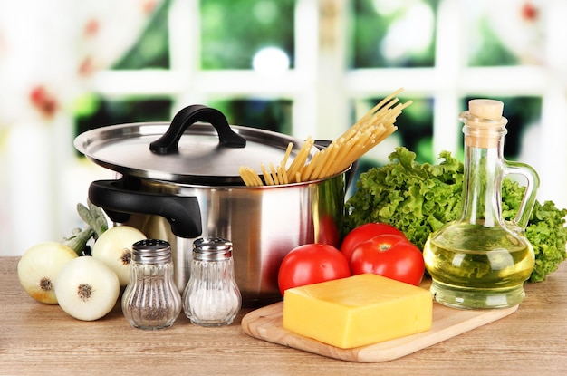 ingredients for cooking pasta on table in kitchen