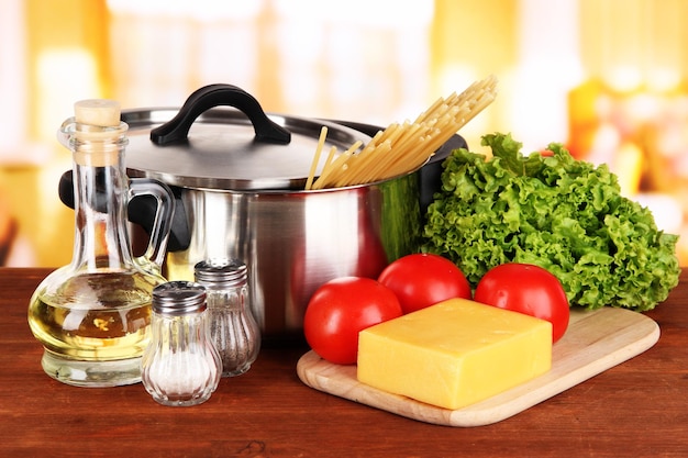 ingredients for cooking pasta on table in kitchen