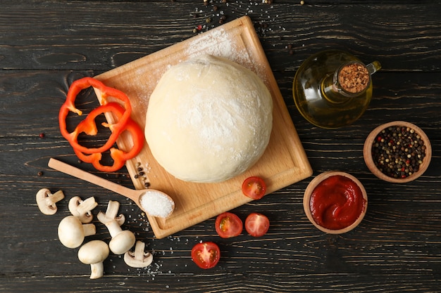 Ingredients for cooking pizza on wooden background