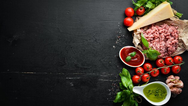 Ingredients for cooking sauce Bolognese On a black background Top view Free space for your text