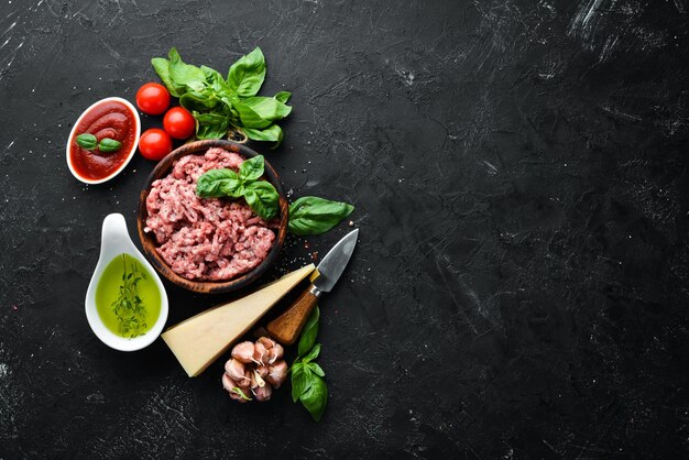 Ingredients for cooking sauce Bolognese On a black background Top view Free space for your text