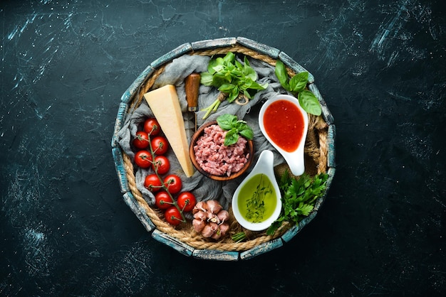 Ingredients for cooking sauce Bolognese On a black background Top view Free space for your text