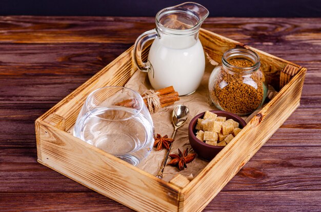 Ingredients for Dalgon coffee in a box on a wooden background