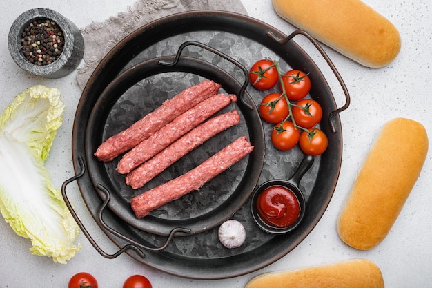 Ingredients for different homemade hot dogs on gray concrete\
table background top view flat lay