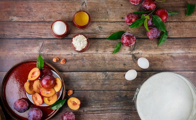 Ingredients for dough for plum cake on wooden table. Flat lay.