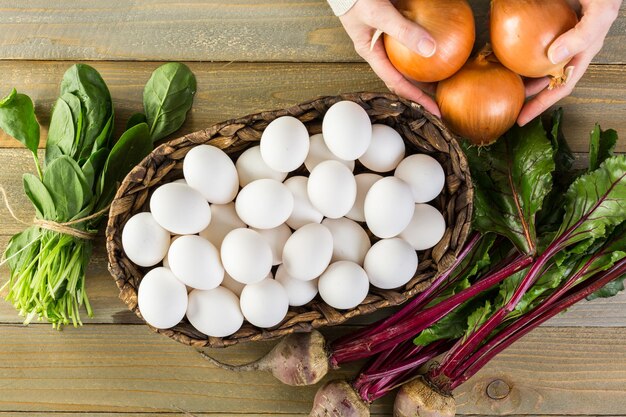 Ingredients for dyeing Easter eggs on a wood table.