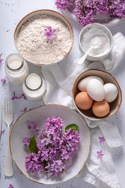 Ingredients for fried lilac flower in pancake dough