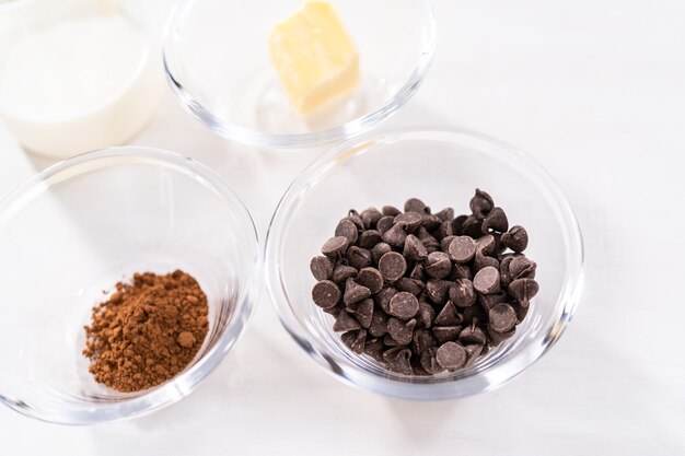 Ingredients in glass bowls to bake chocolate bundt cake with chocolate frosting.