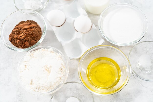 Ingredients in glass mixing bowls to bake s'mores cupcakes.