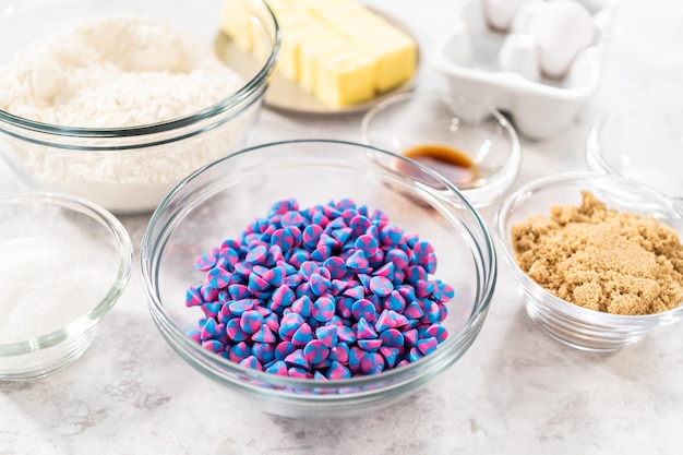 Ingredients in glass mixing bowls to bake unicorn chocolate chip cookies.